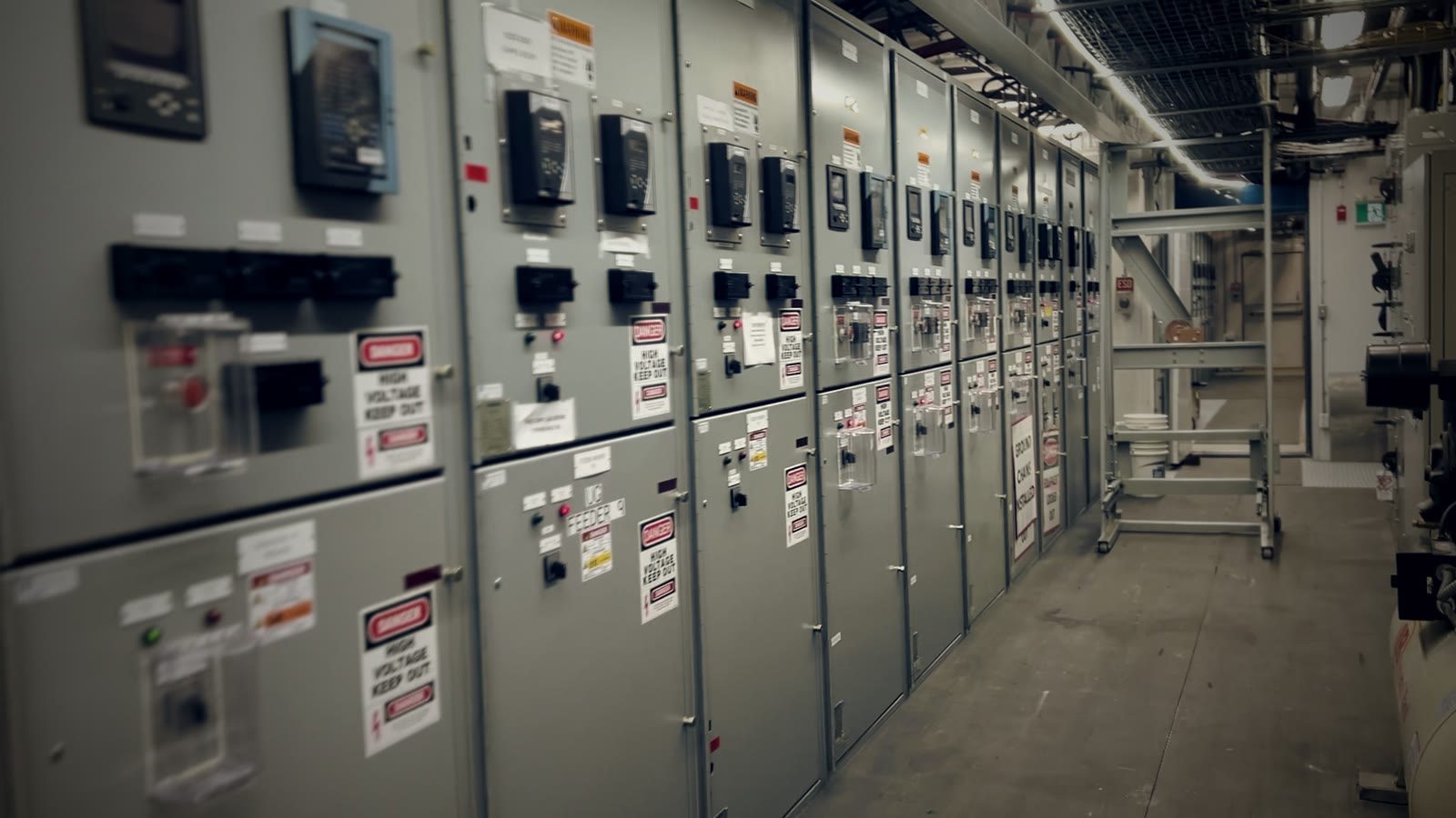 Medium-voltage switchgear line-up with warning labels on each section