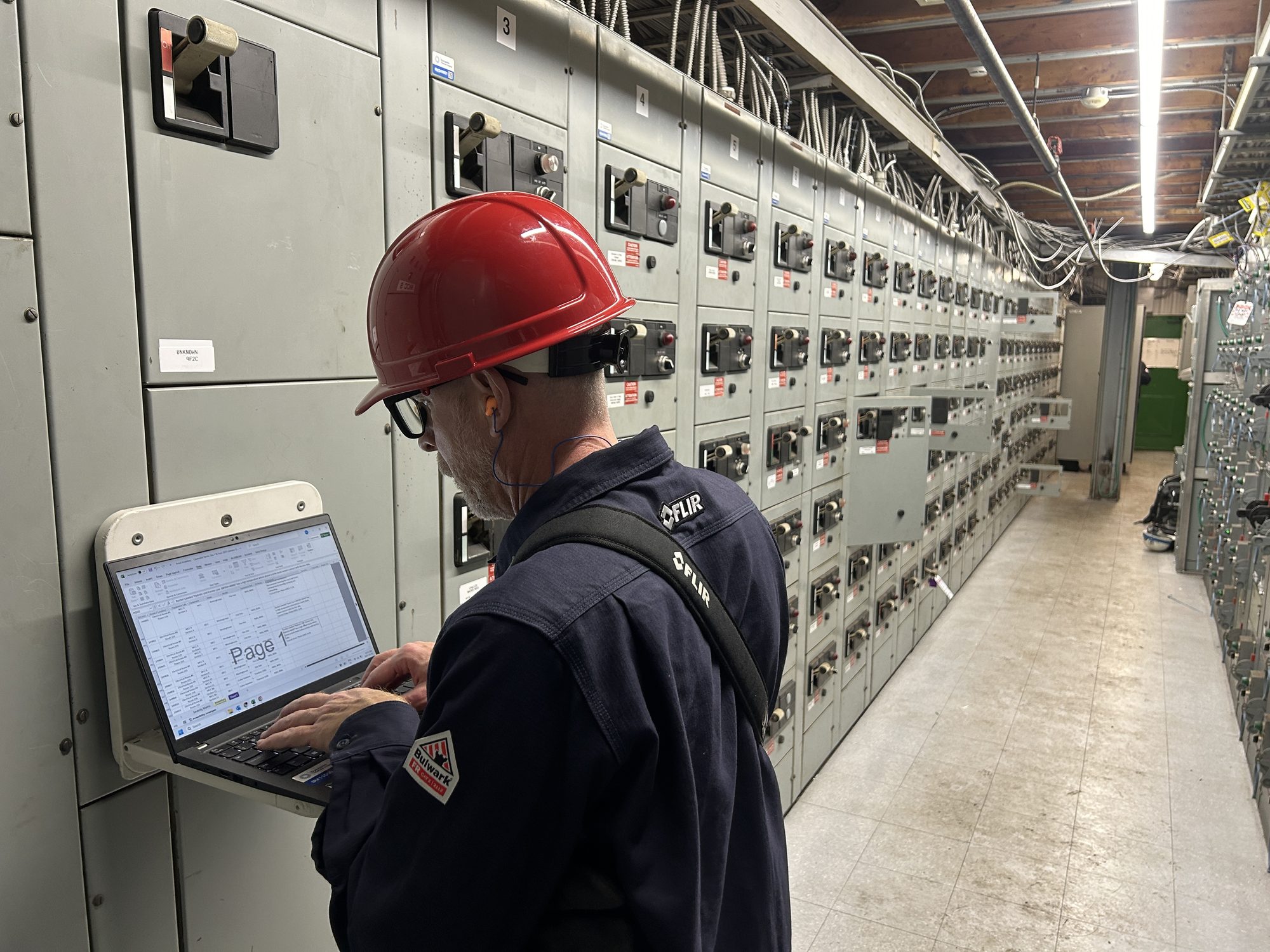 A Dynamic Thermal Imaging technician recording every detail of each piece of electrical equipment and adding it to a digital repository for eacy look-up.