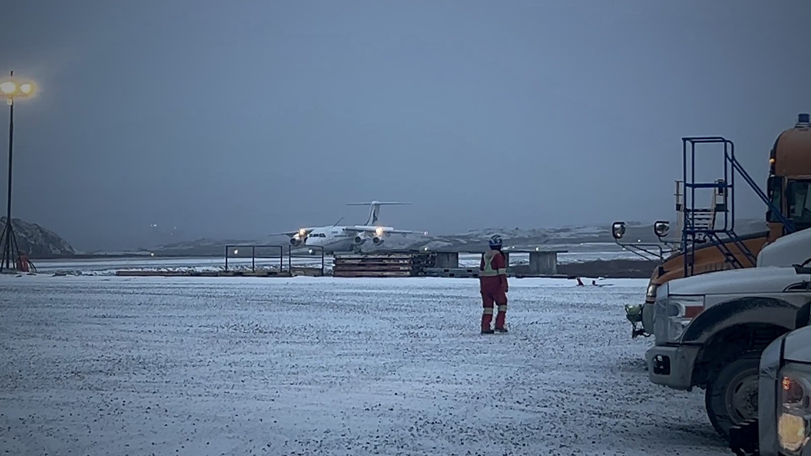 Charter aircraft on a snowy gravel airstrip at a remote northern mine site