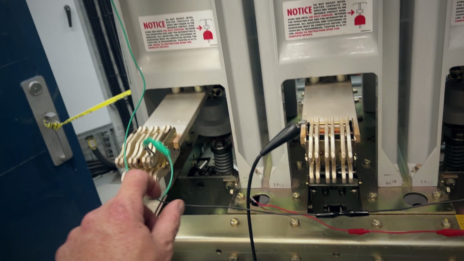 Primary disconnect fingers on a draw-out breaker with test leads attached