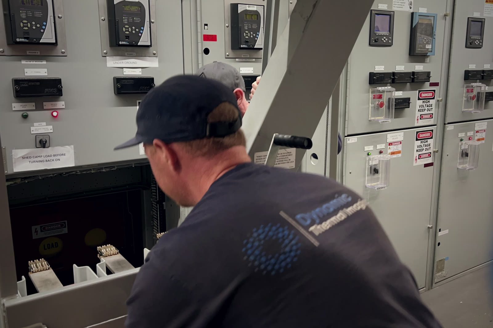 DTI electrician racking a draw-out medium-voltage breaker out of its cell
